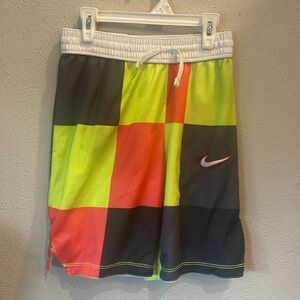 Nike youth size L dry fit reversible mesh shorts. White, black, green, yellow